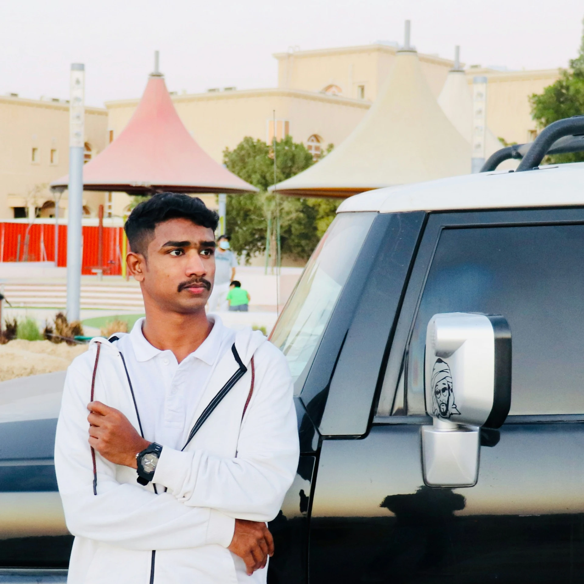 a man leans against the door of his truck