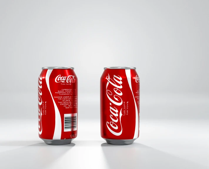 two red cans of coke cola with one open
