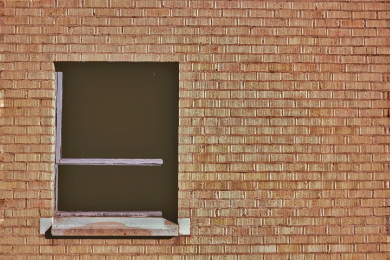 a window that is sitting next to a brick building