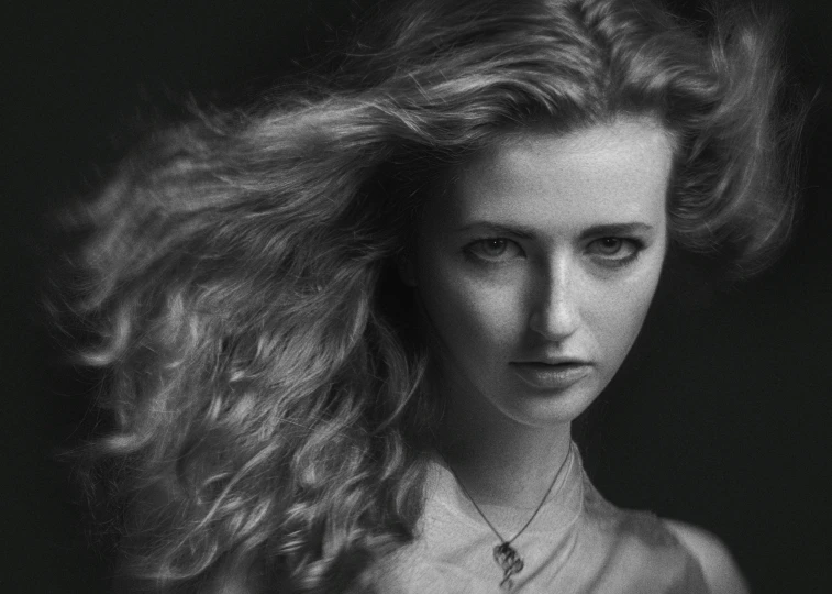 a black and white po of a woman with long hair