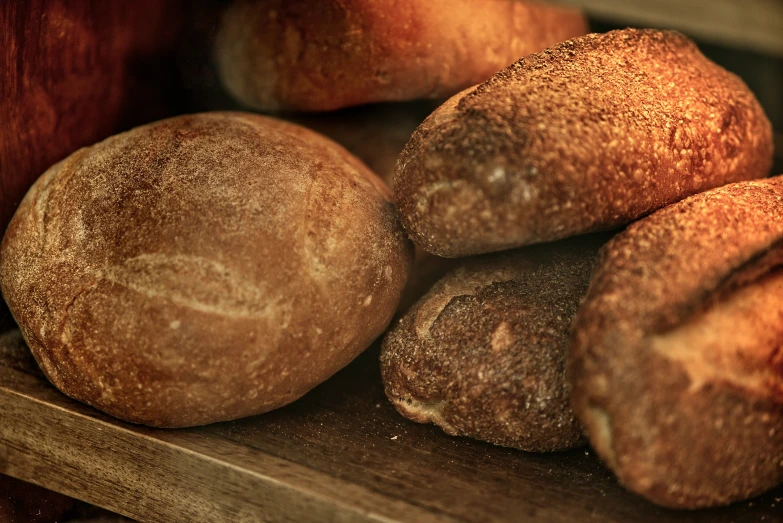 a bunch of breads stacked on a table