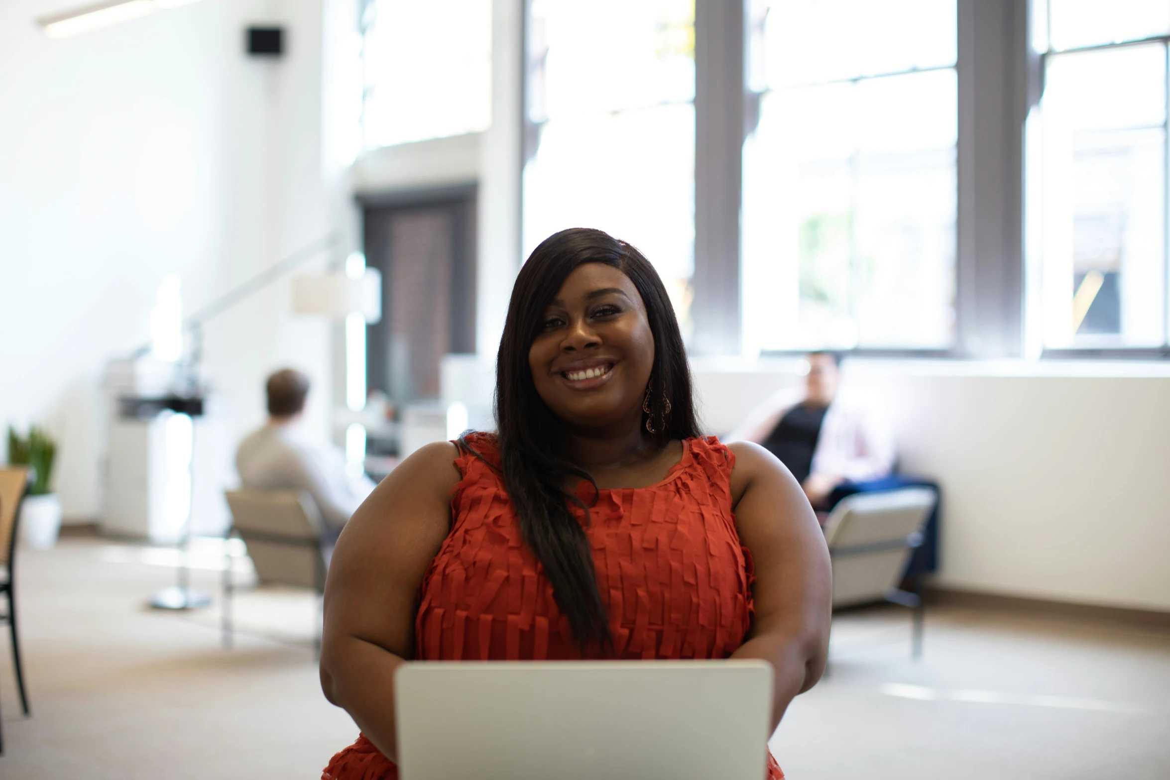 woman sitting on the couch while using a laptop