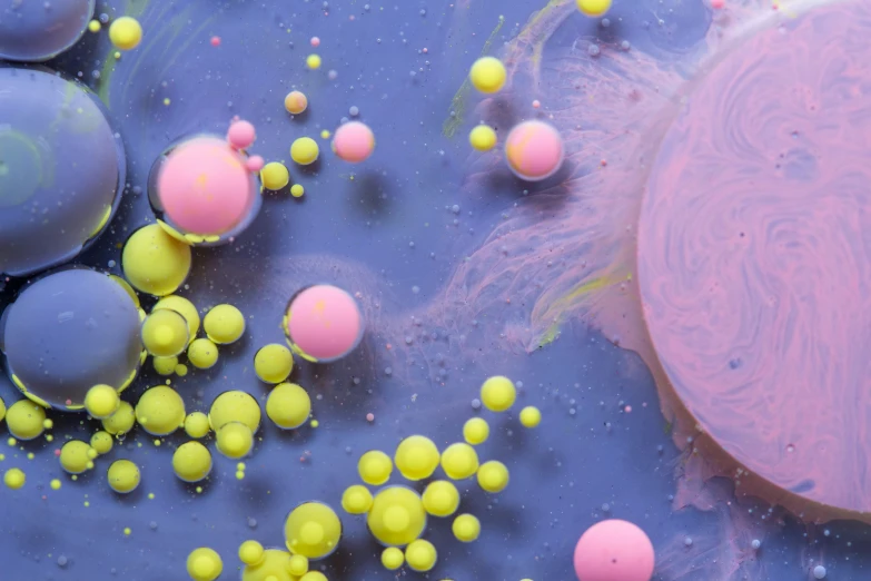 an image of some pink and yellow bubbles in water