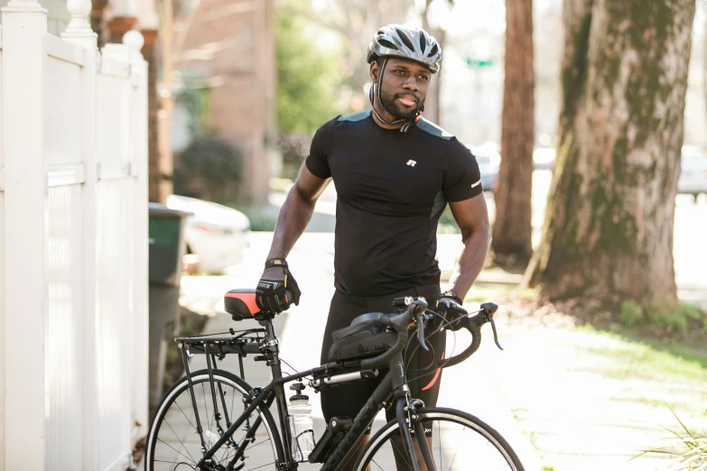 the man stands with his bicycle by himself