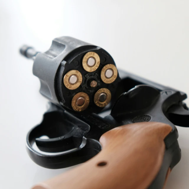 an image of a toy revolver gun and action s