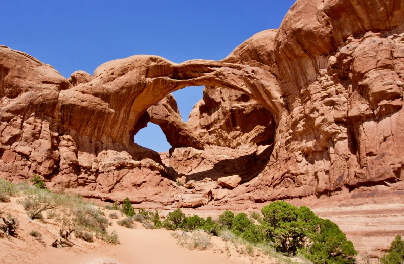 a rock formation with trees and a small body of water