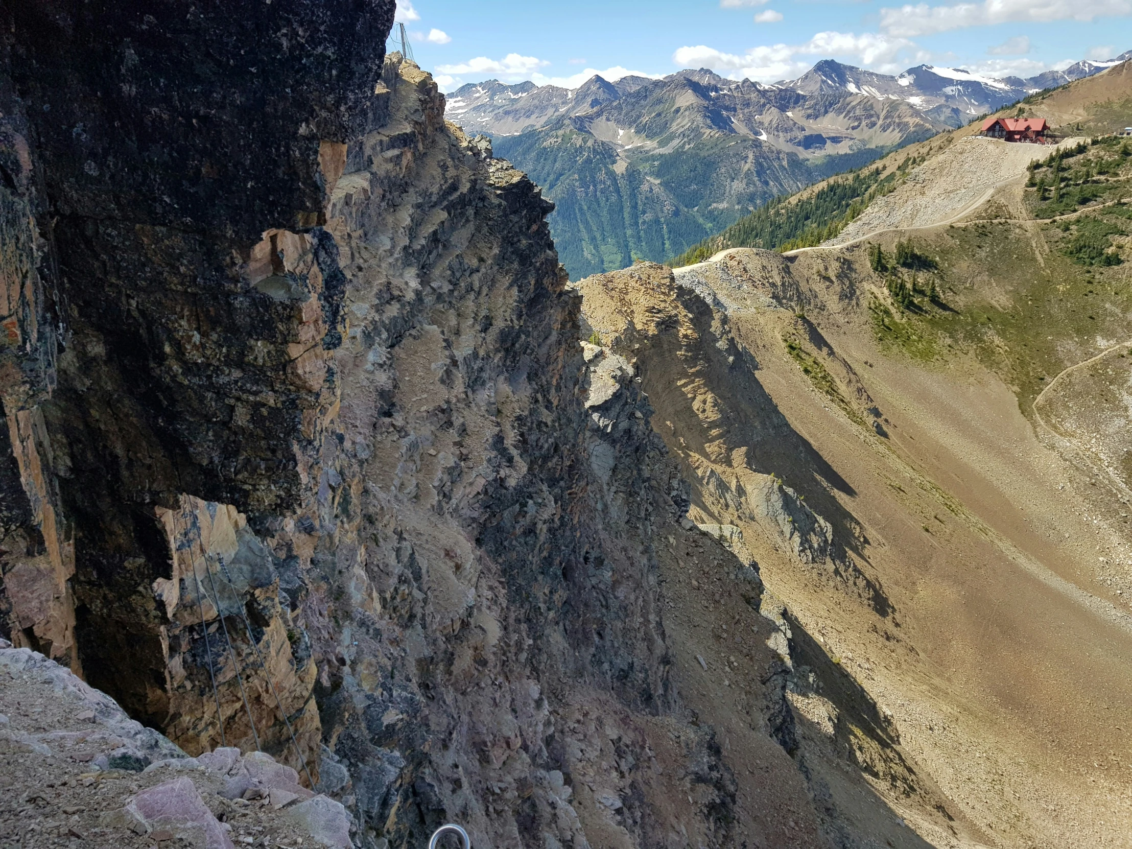 a large mountain is shown as seen from the edge of a cliff