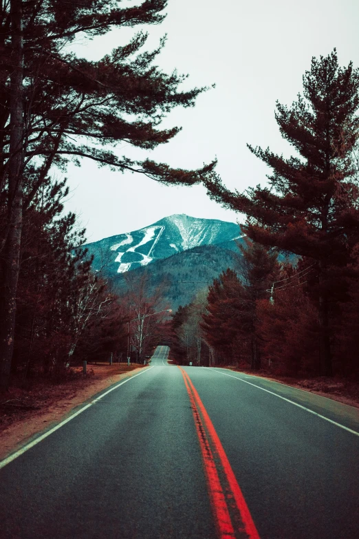 a long road with the mountain in the background