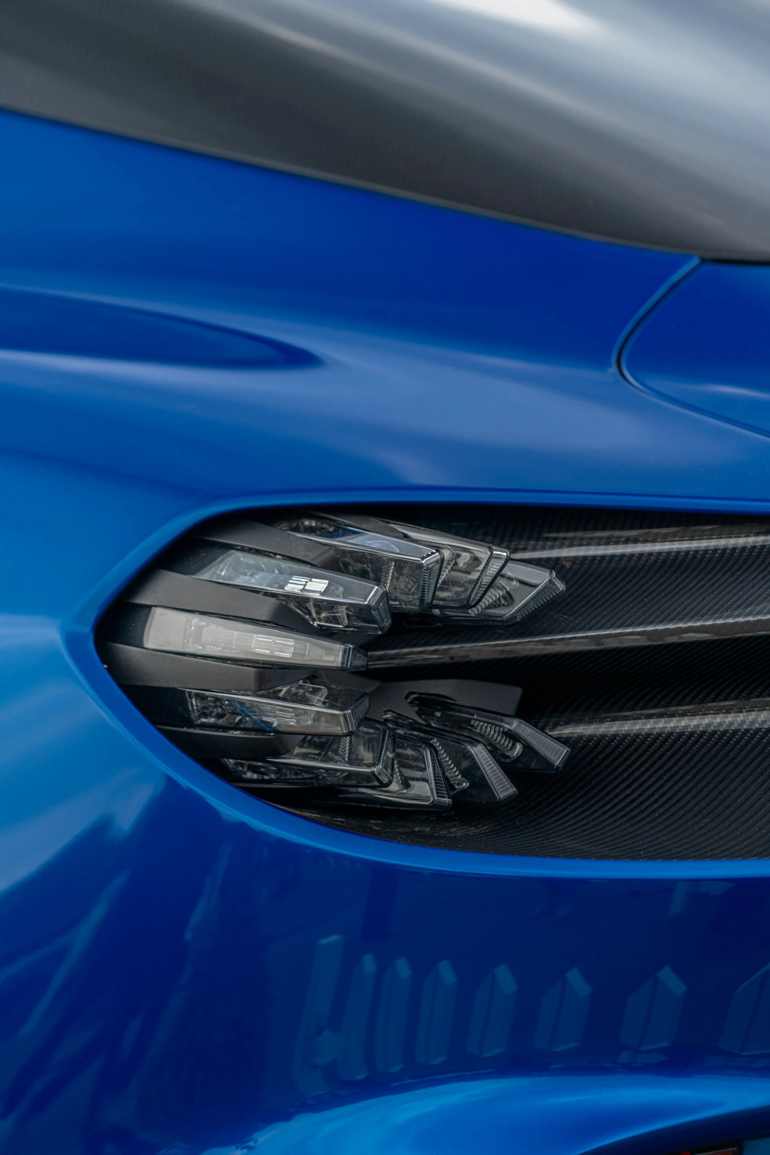 a closeup of the rear bumper of a blue sports car