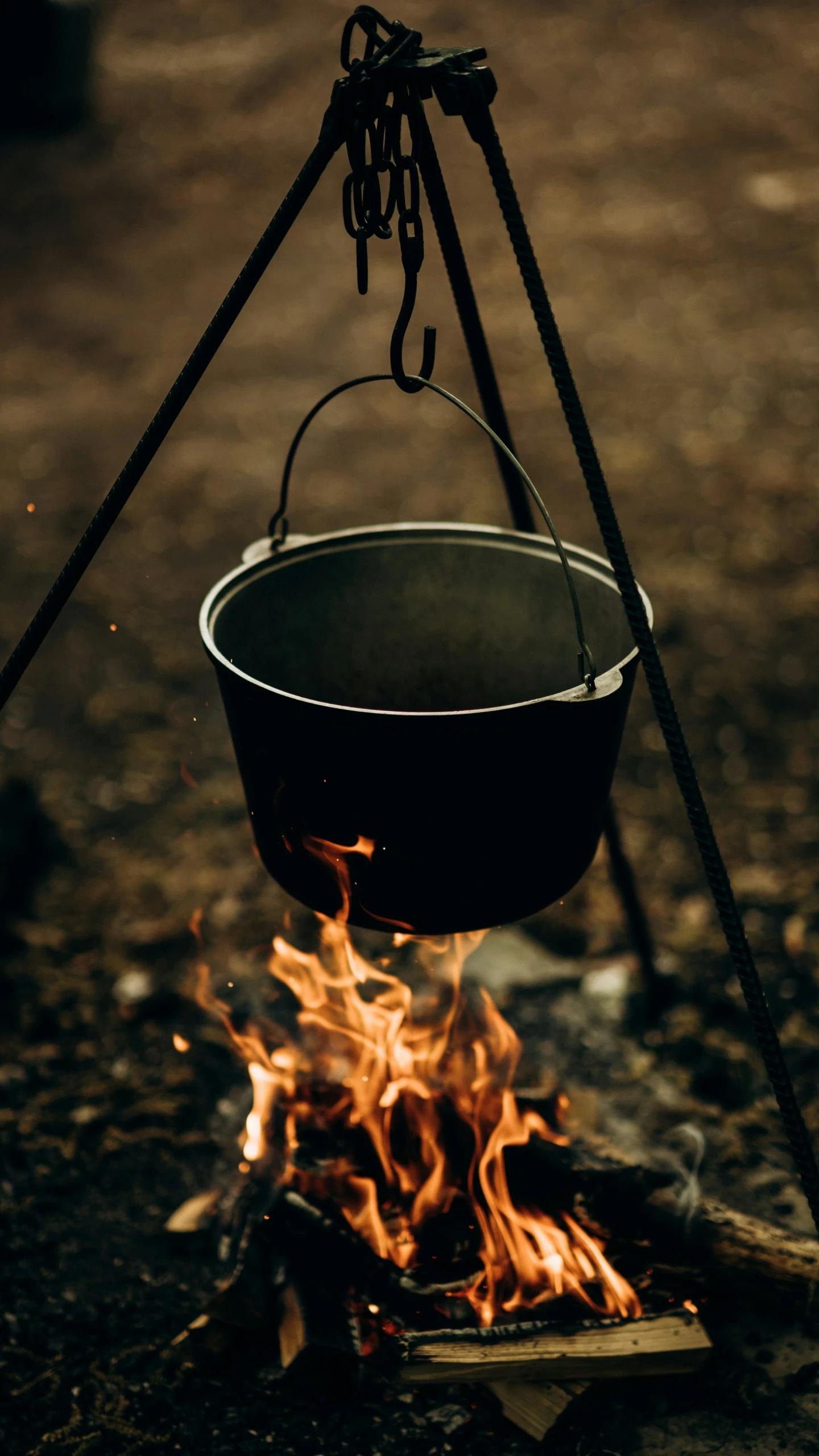 a large pot cooking on fire in front of a stove