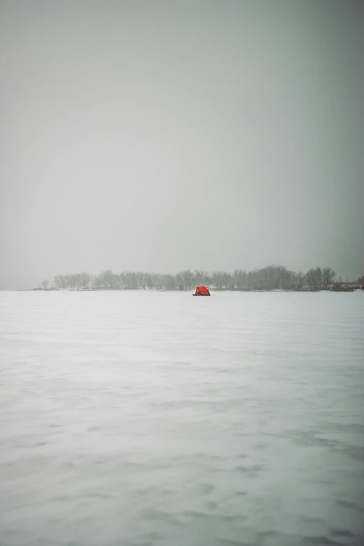 a lone house sitting in the snow on top of a hill