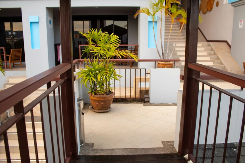 a stairway leads to the balcony where some tables are seen