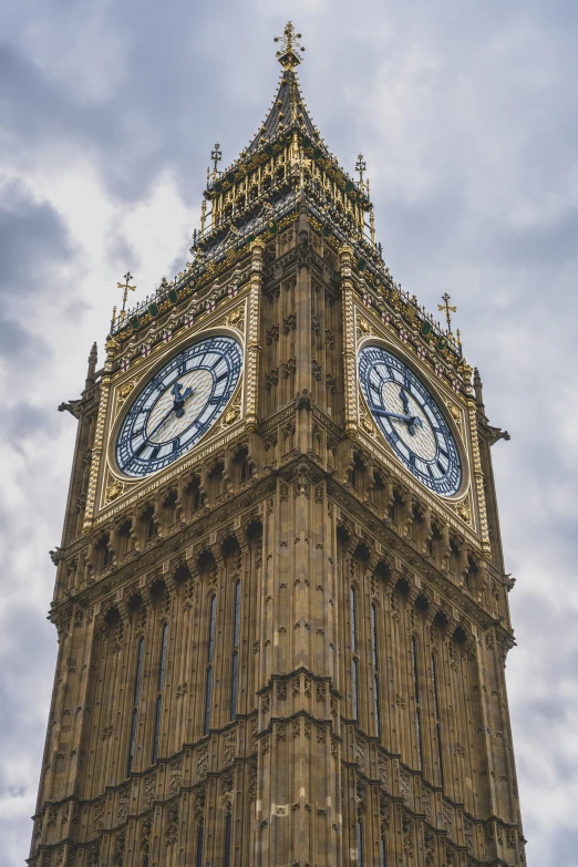 the clock tower in front of some cloudy sky