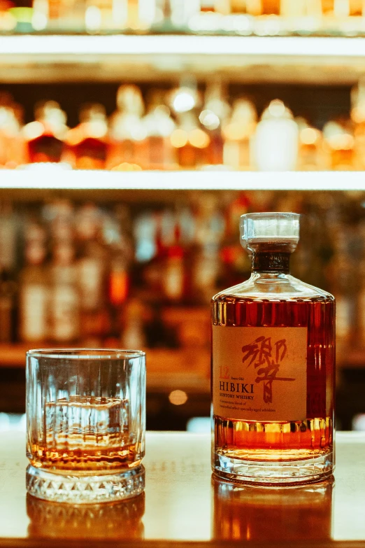 two whiskey glasses sitting on the counter beside one another