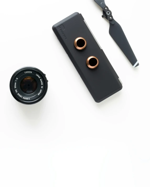 two pairs of tiny rose gold earrings, and a camera