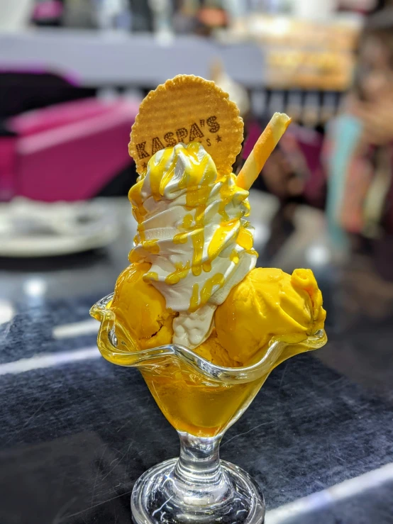 an ice cream sundae sits in a glass bowl