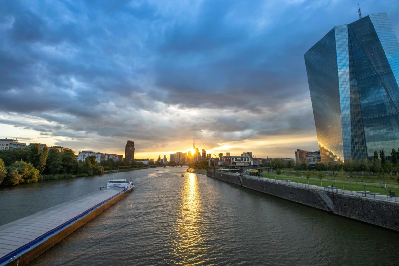 a large river runs next to tall buildings