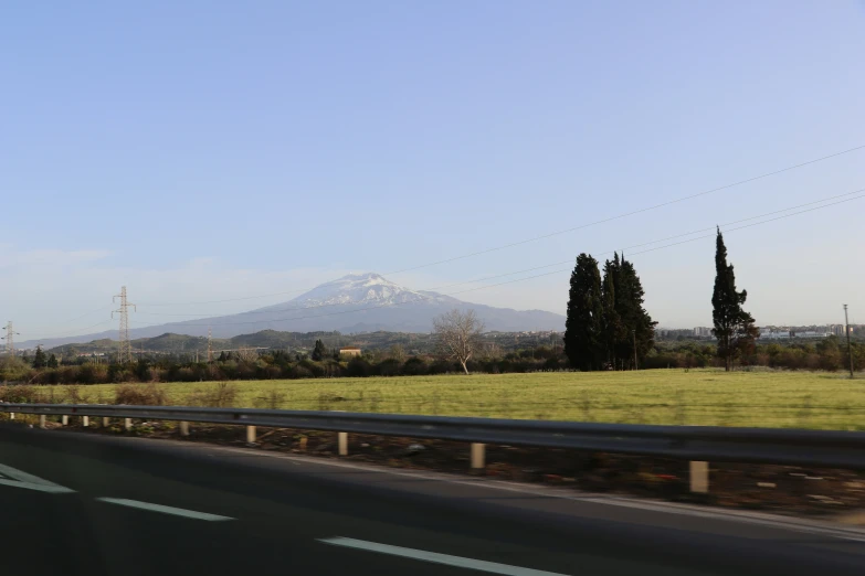 mountains and highway with grass in foreground