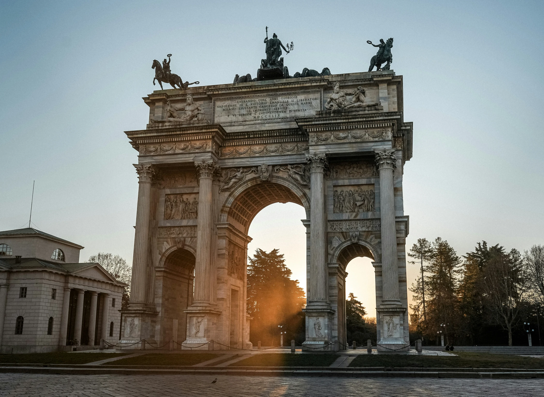 a large stone arch with a statue at the top