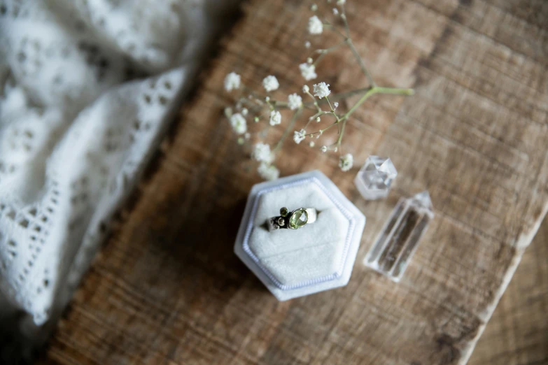 an antique trinket with two engagement rings sitting next to it