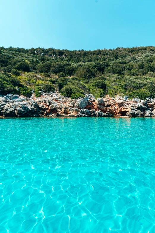 this is an image of a blue ocean with a rock shoreline