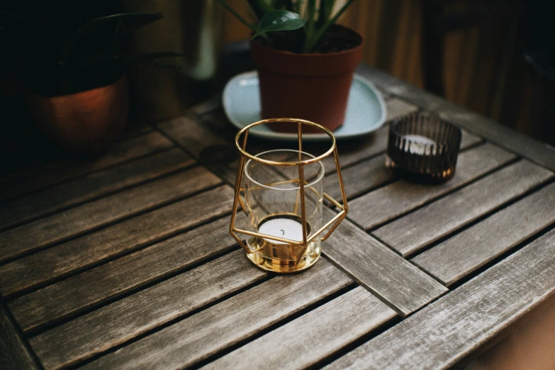 a vase that has a candle on a table