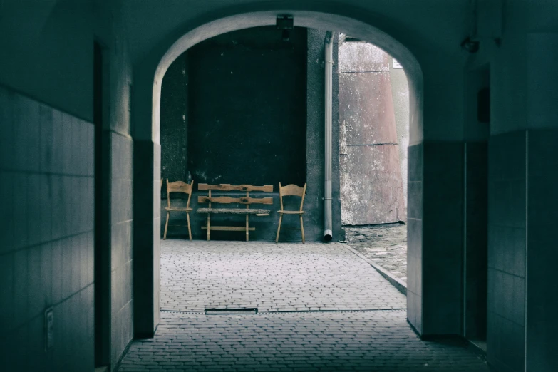 a long arched doorway with many chairs in it