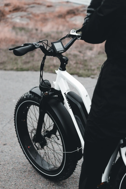 a person holding the handlebars of a motorbike