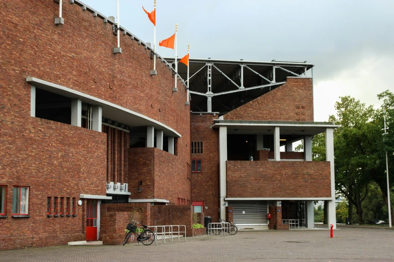 some flags that are standing on a brick building