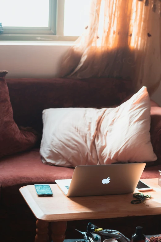 an open lap top sitting on top of a wooden table