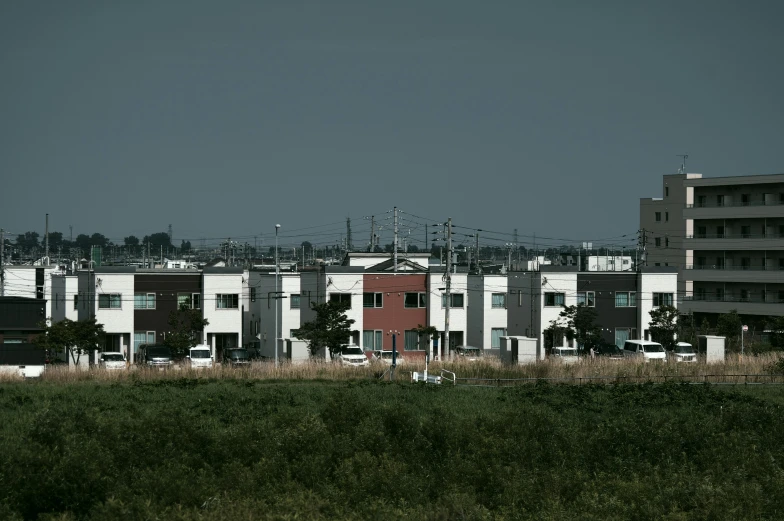 a group of three white buildings on a street