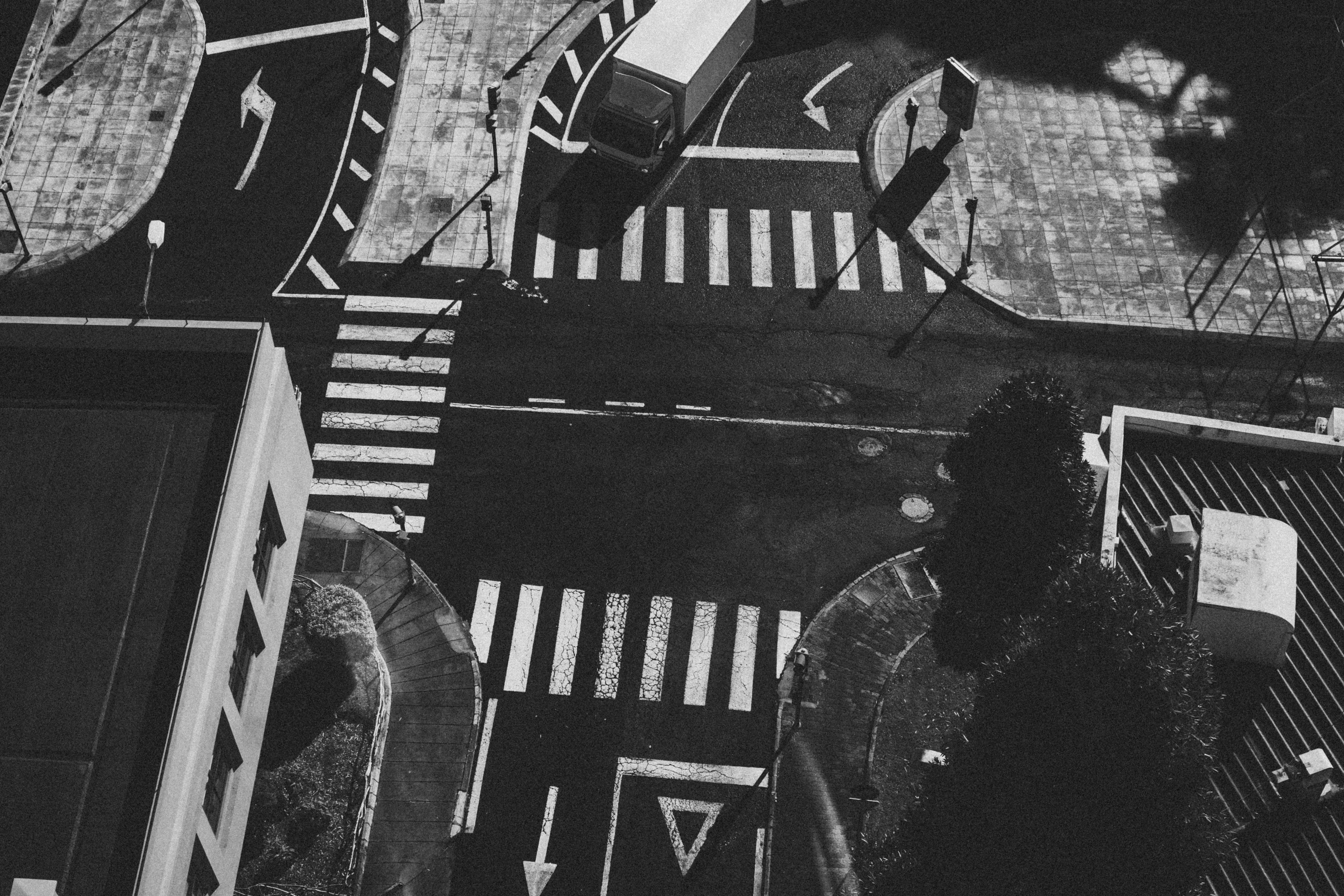 a man standing on a city street next to parked vehicles