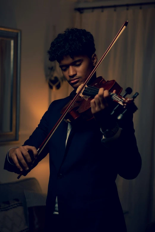 a person in a dark room playing violin