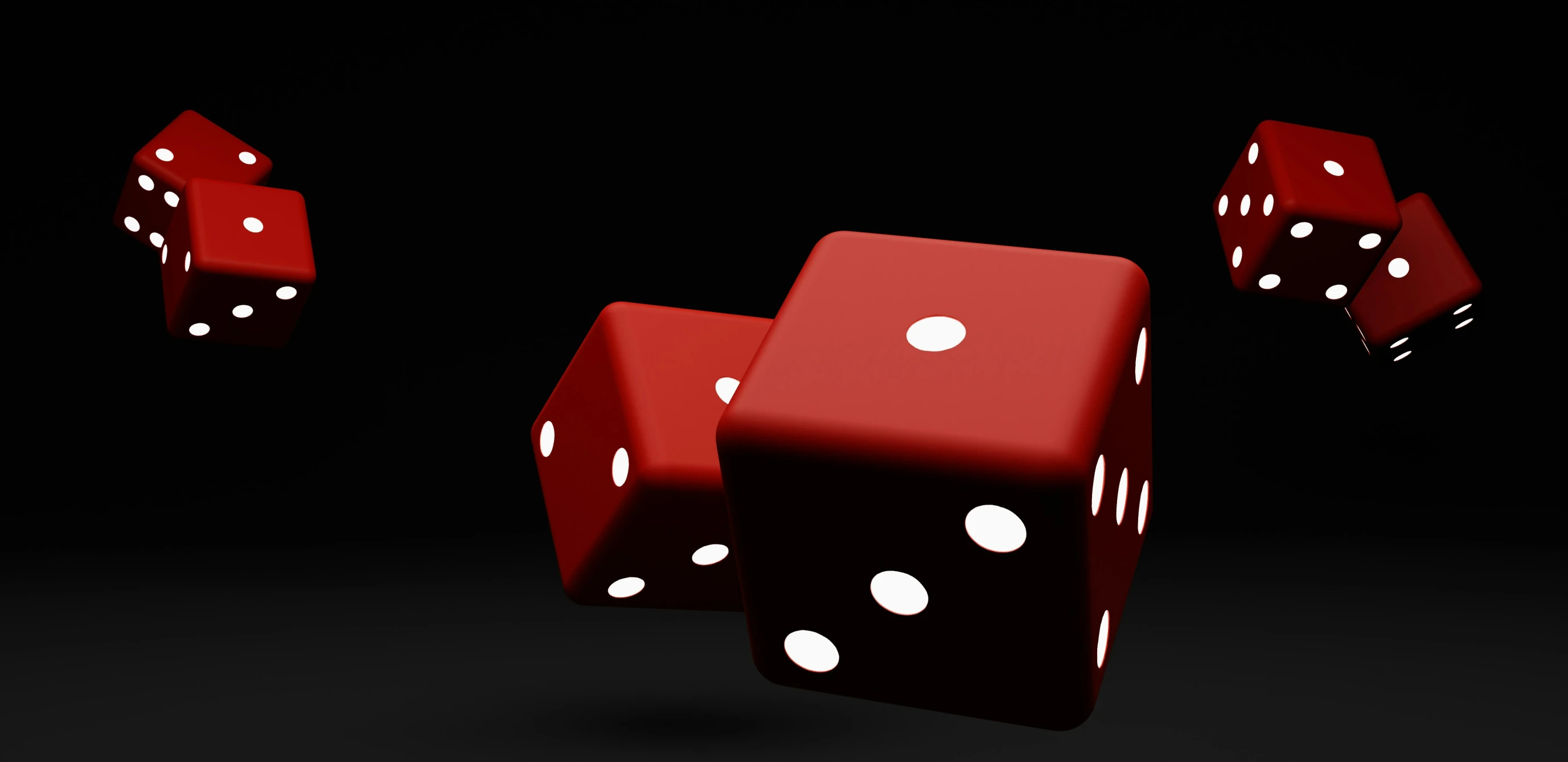 several red dices and one falling on black background