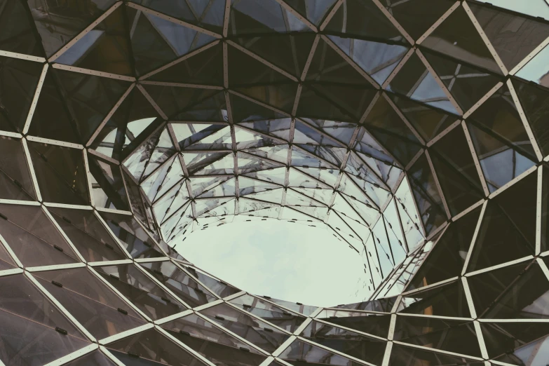 looking up at the glass wall of a sculpture