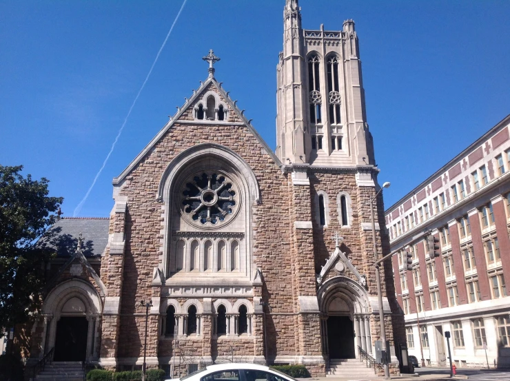 a small car parked in front of an old church