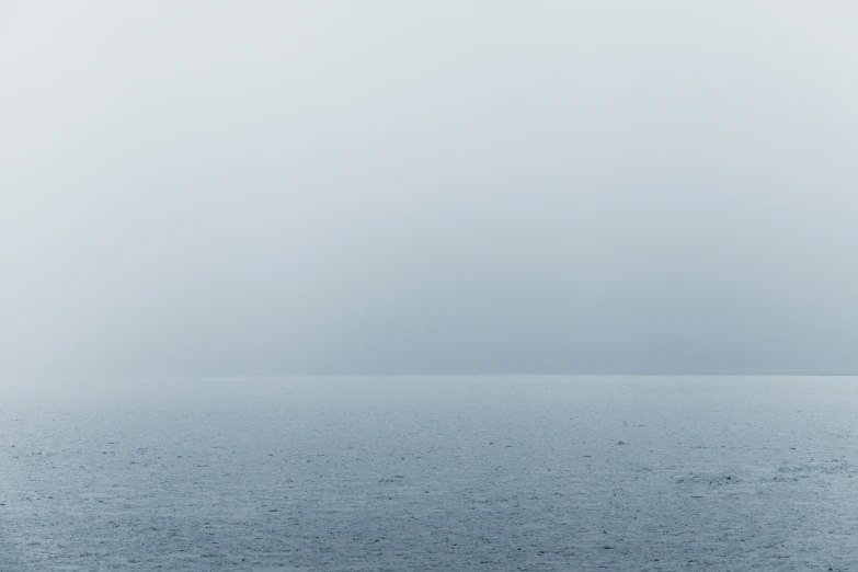 a lone boat floating on the water at night