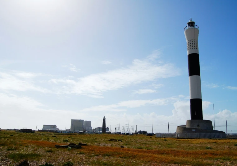 a light tower on a hill surrounded by buildings