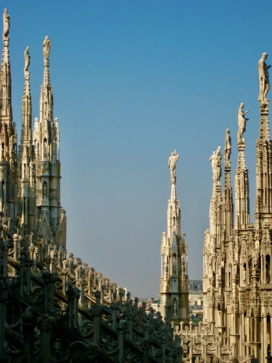 a row of ornate statues with clear sky