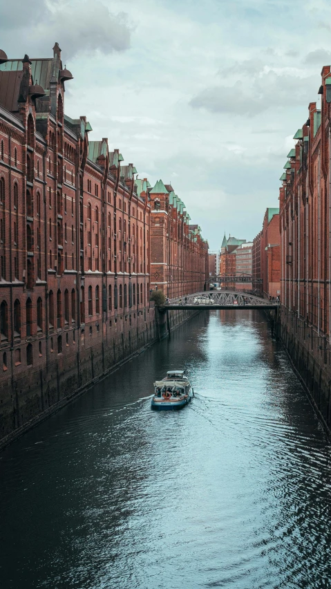 the boats are traveling down the canal between buildings