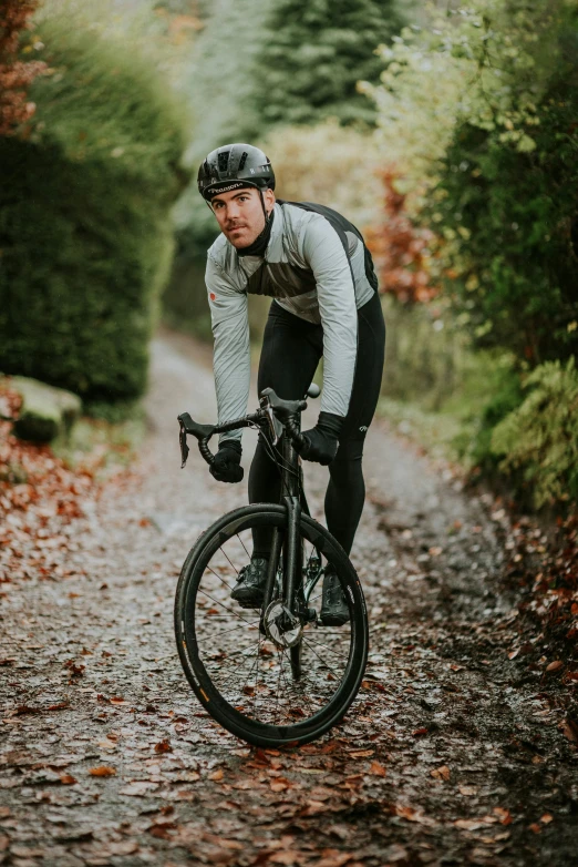 a man riding a bike on a forest path