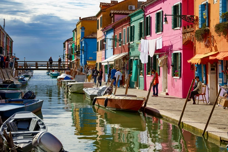 a bunch of colorful boats docked in the water