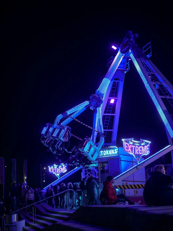 people on a roller coaster ride at night