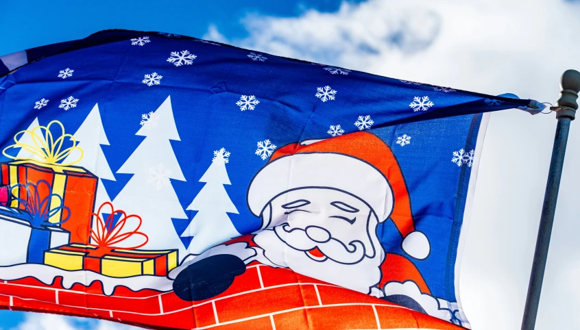 a colorful santa clause waving a blue flag