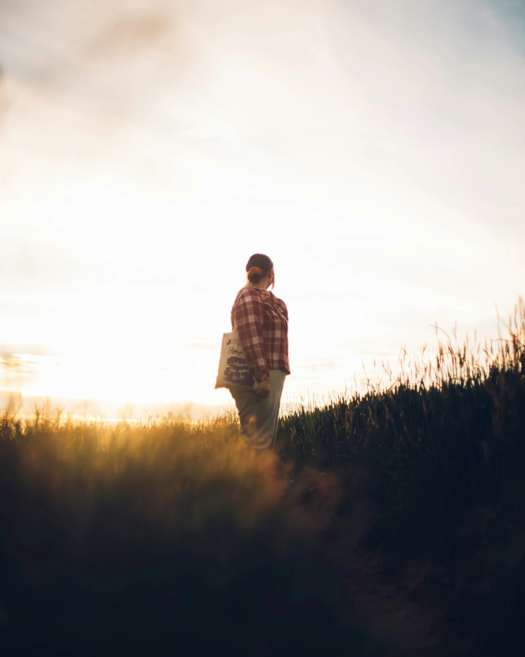 a man walking alone into the distance in a field