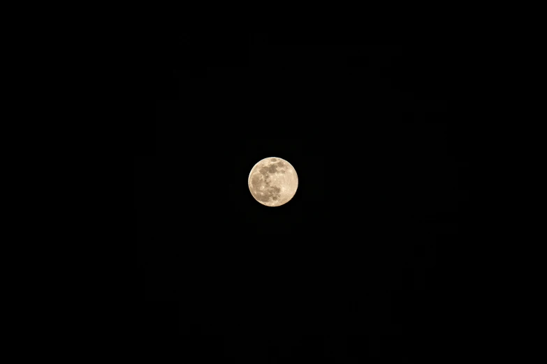 the moon can be seen through the clear black night sky