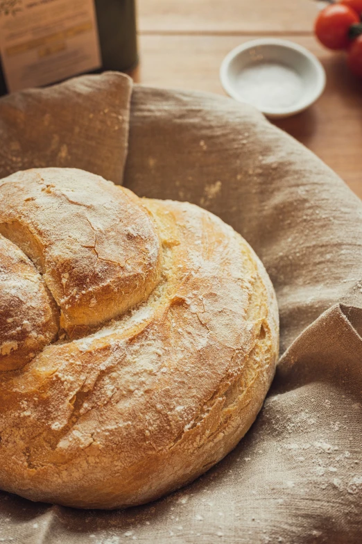 three loaves of bread sitting in a basket next to a plate