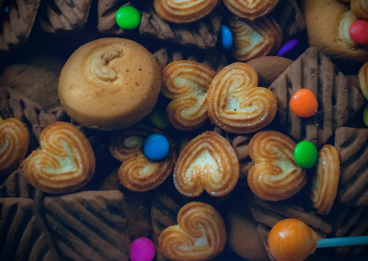 various pastries and candy are stacked up on a table