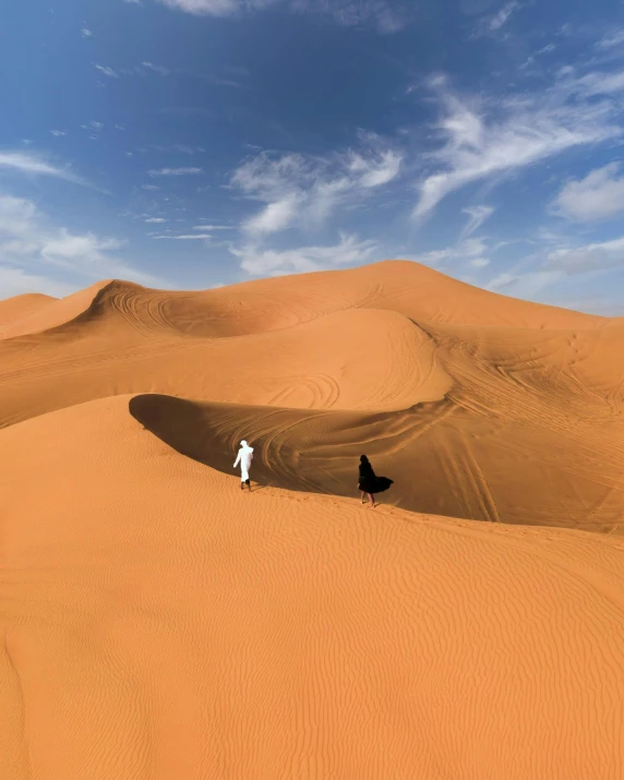 person with hat on in the middle of desert