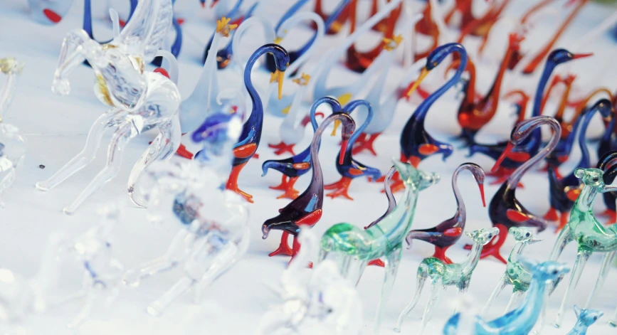 an array of colorful glass figurines sitting on display